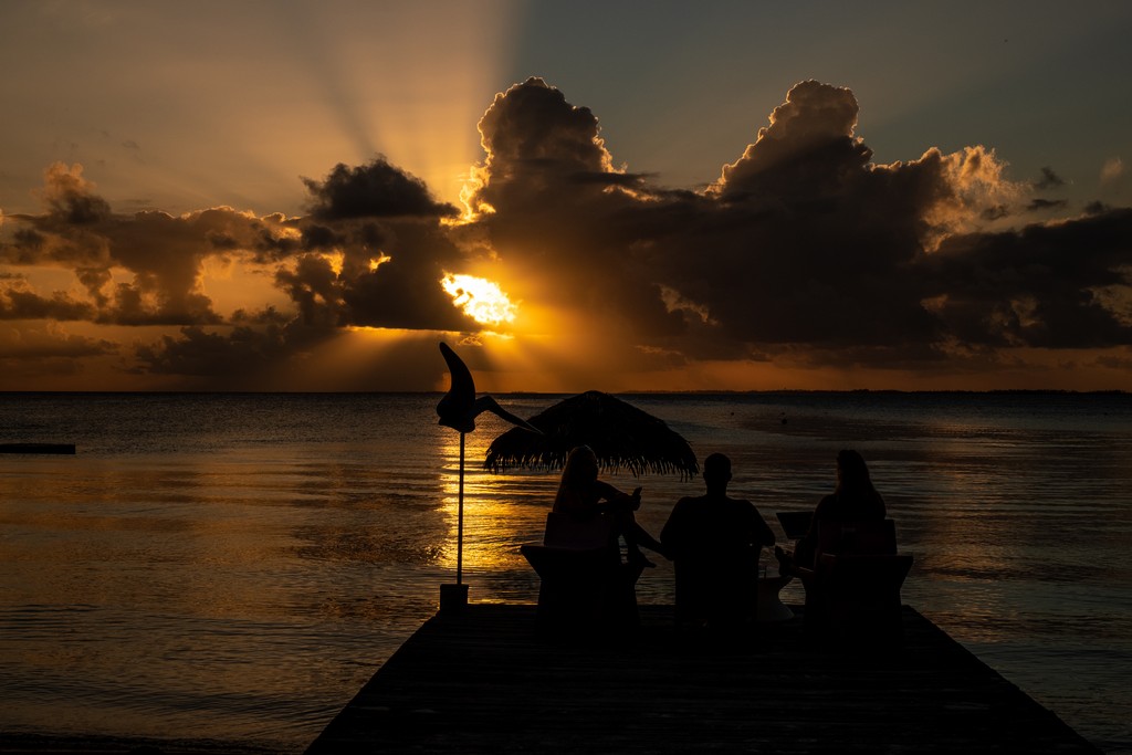 persone guardano il mare al tramonto